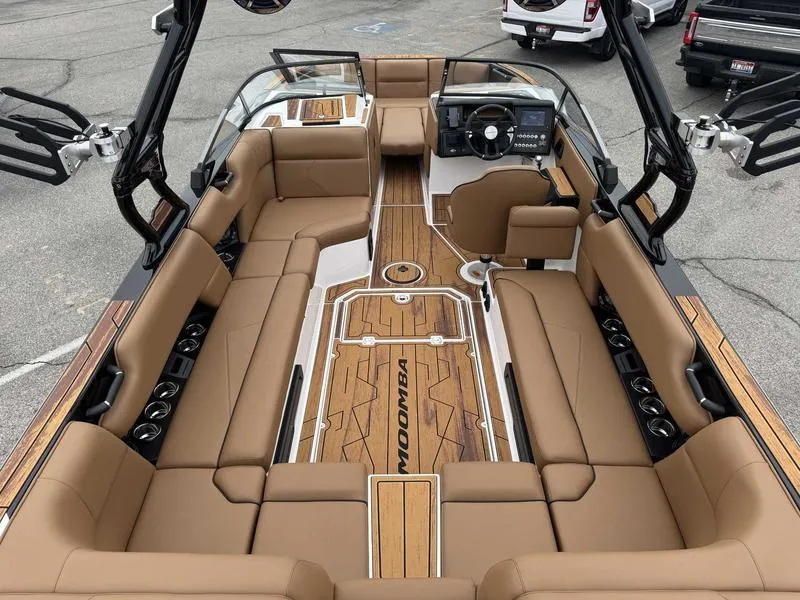 Slide: The Image of 2025 Moomba Tykon boat interior with tan seating and sleek design. - 9