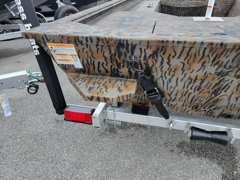 Slide: The Image of 2025 Xpress HD16DB duck hunting boat with camouflage design and trailer attachment. - 3