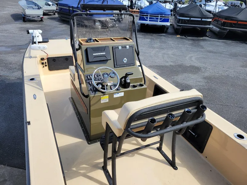 Slide: The Image of 2021 KenCraft Duck Rider 2060 skiff with Yamaha 115, center console, parked among boats. - 12