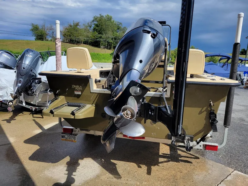 Slide: The Image of 2021 KenCraft Duck Rider 2060 skiff with Yamaha 115 engine, parked outdoors. - 3