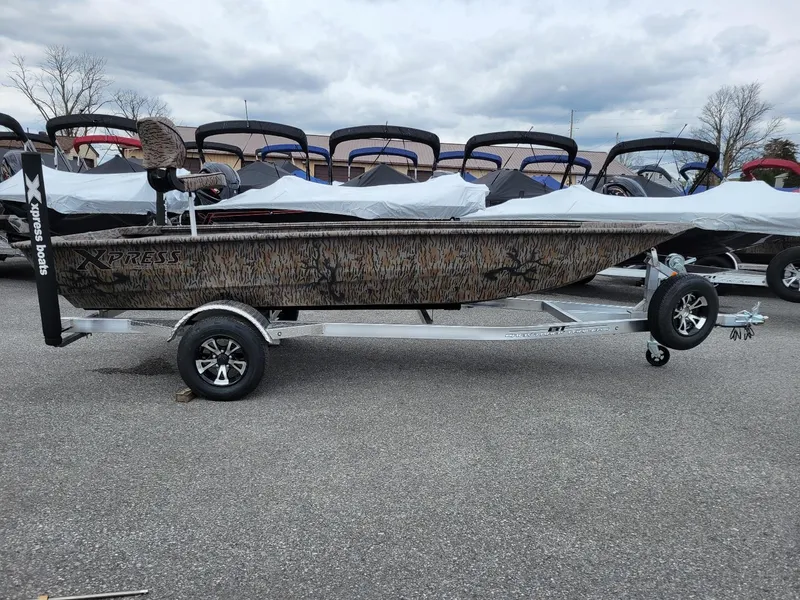 The Image of 2025 Xpress HD16DB duck hunting boat with Yamaha 50 hp engine on trailer. - 1