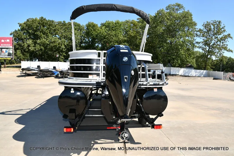 Slide: The Image of 2025 Ranger 243C Cruise boat with 250HP Mercury 4 Stroke engine, parked outdoors. - 15