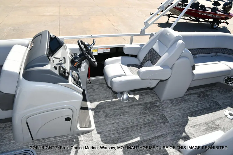 Slide: The Image of Interior of 2025 Ranger 243C Cruise boat with modern helm and seating. - 24