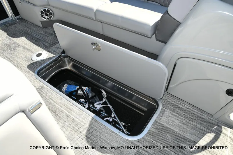 Slide: The Image of 2025 Ranger 243C Cruise boat storage compartment with open lid, revealing interior space. - 31