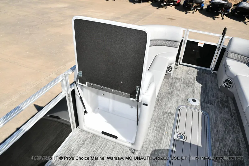 Slide: The Image of 2025 Ranger 243C Cruise boat interior with open storage compartment and seating. - 33