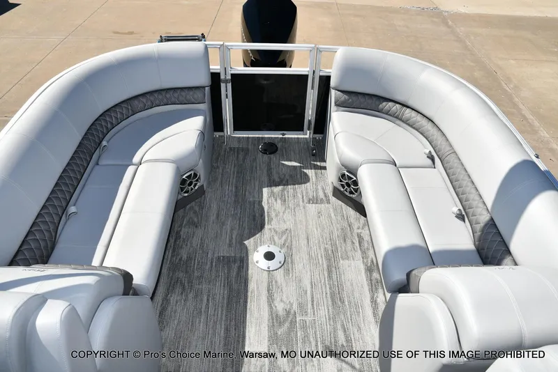 Slide: The Image of 2025 Ranger 243C Cruise boat interior with gray seating and flooring. - 35