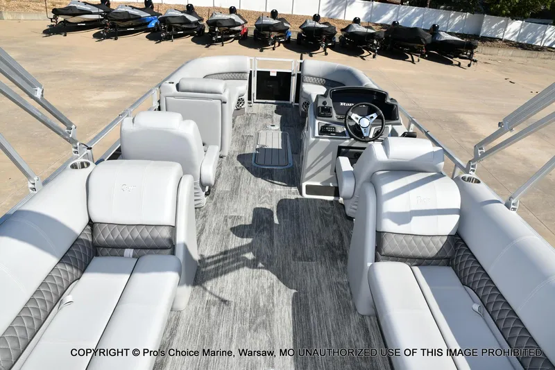 Slide: The Image of 2025 Ranger 243C Cruise boat interior with luxurious seating and modern dashboard. - 40