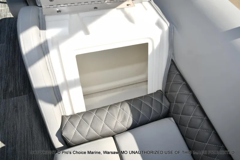 Slide: The Image of 2025 Ranger 243C Cruise boat interior storage compartment with quilted seating. - 44