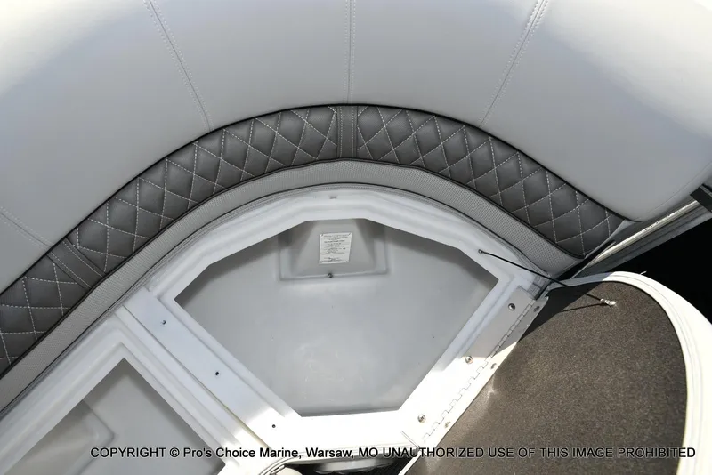 Slide: The Image of 2025 Ranger 243C Cruise boat interior with quilted seating and storage compartment. - 46