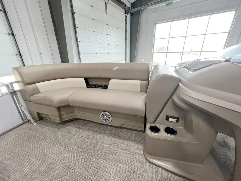Slide: The Image of 2023 Starcraft LX 22 R boat interior with beige seating and cup holders. - 11