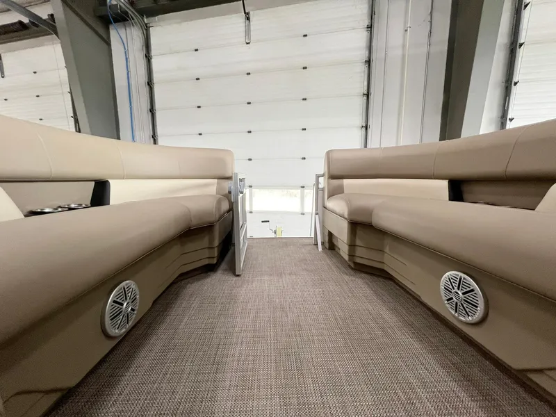 Slide: The Image of 2023 Starcraft LX 22 R interior with beige seating and built-in speakers. - 12