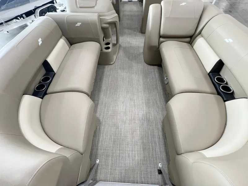 Slide: The Image of 2023 Starcraft LX 22 R boat interior with beige seating and cup holders. - 16