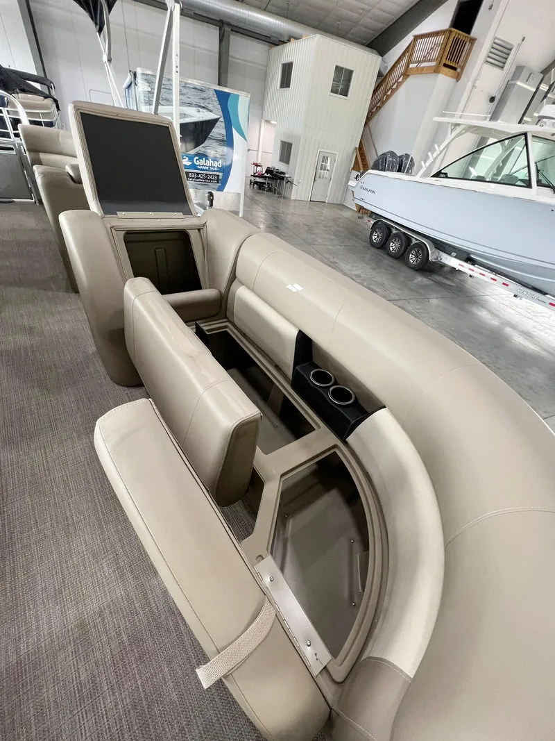 Slide: The Image of 2023 Starcraft LX 22 R boat interior with beige seating and storage compartments. - 18