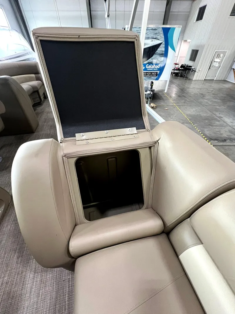 Slide: The Image of 2023 Starcraft LX 22 R boat seat with open storage compartment. - 19
