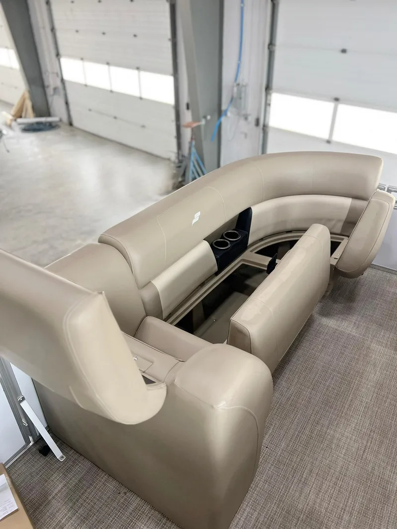 Slide: The Image of 2023 Starcraft LX 22 R boat interior with beige seating and cup holders. - 25