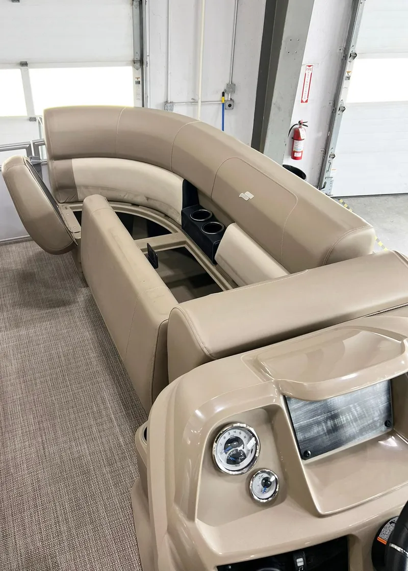 Slide: The Image of 2023 Starcraft LX 22 R boat interior with beige seating and control panel. - 26