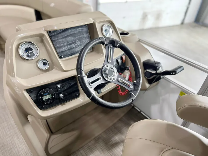 Slide: The Image of 2023 Starcraft LX 22 R boat dashboard with steering wheel and control panel. - 3