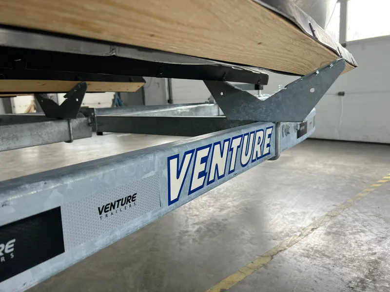 Slide: The Image of 2023 Starcraft LX 22 R on Venture trailer in a garage setting. - 32