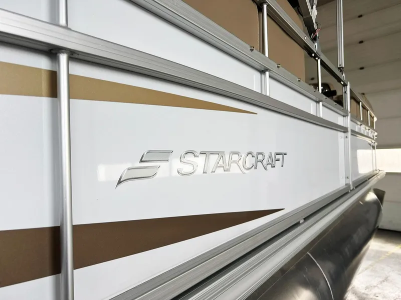 Slide: The Image of 2023 Starcraft LX 22 R pontoon boat, close-up of logo and side panel design. - 34