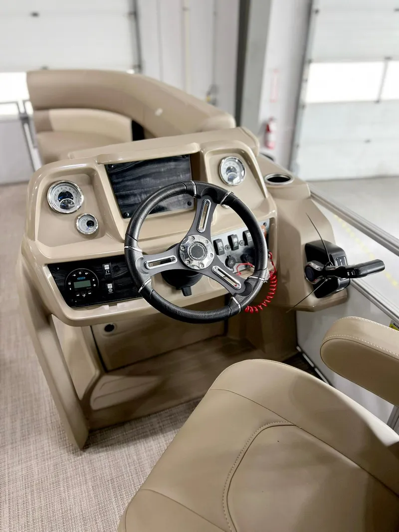 Slide: The Image of 2023 Starcraft LX 22 R boat interior with steering wheel and dashboard controls. - 5