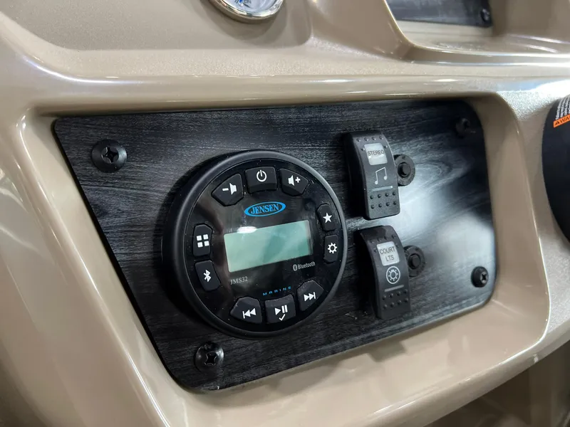 Slide: The Image of 2023 Starcraft LX 22 R dashboard with Jensen audio system and control switches. - 7