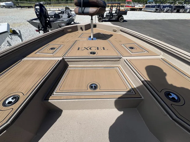 Slide: The Image of Excel New Bay Pro 230 boat deck, 2025 model, with storage compartments and seating. - 10