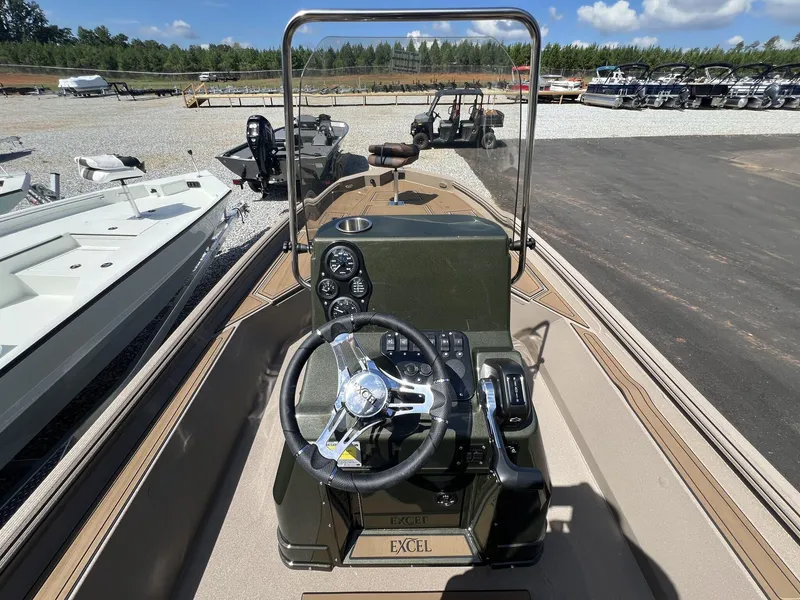 Slide: The Image of 2025 Excel New Bay Pro 230 boat dashboard with steering wheel and controls. - 12