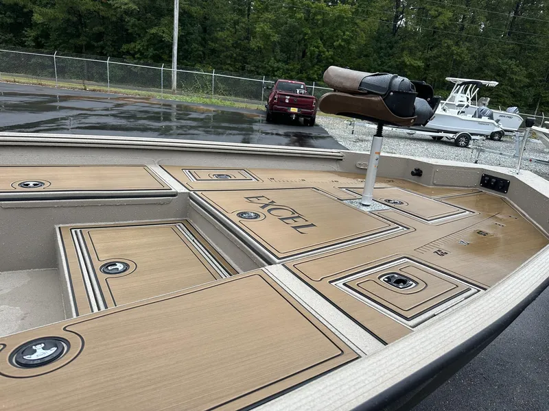 Slide: The Image of 2025 Excel New Bay Pro 230 boat deck with storage compartments and seating. - 14