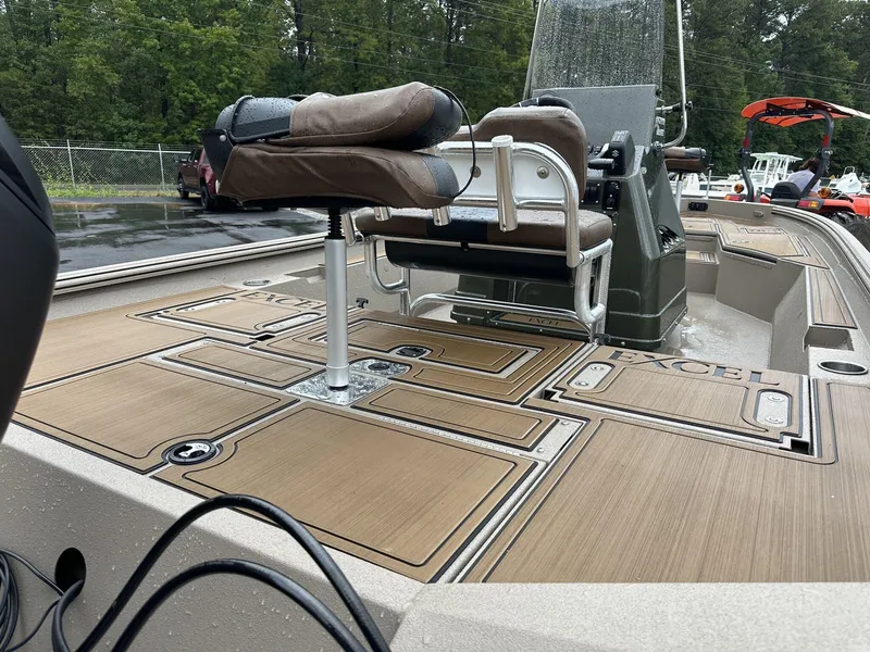 Slide: The Image of 2025 Excel New Bay Pro 230 boat interior with seating and deck details. - 7