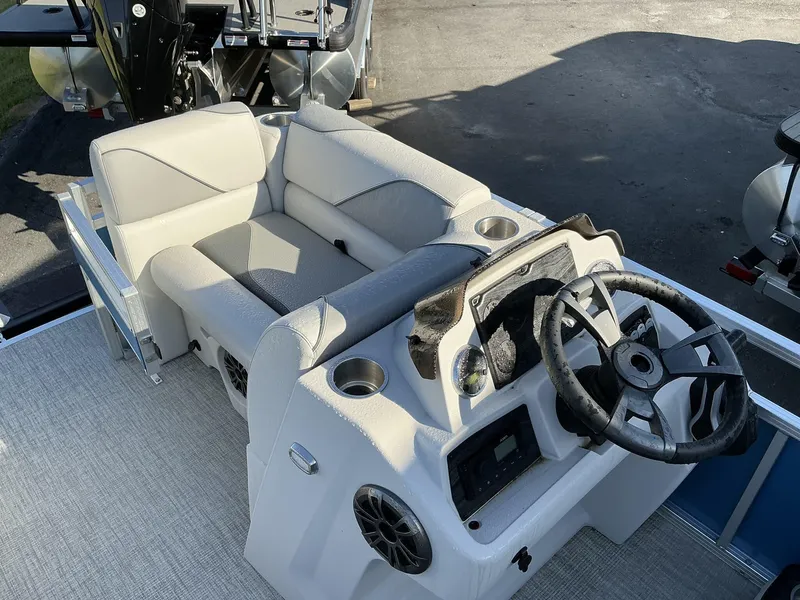 Slide: The Image of 2025 Tahoe Pontoon Boats Sport 17 REAR FISH interior with steering wheel and seating. - 7