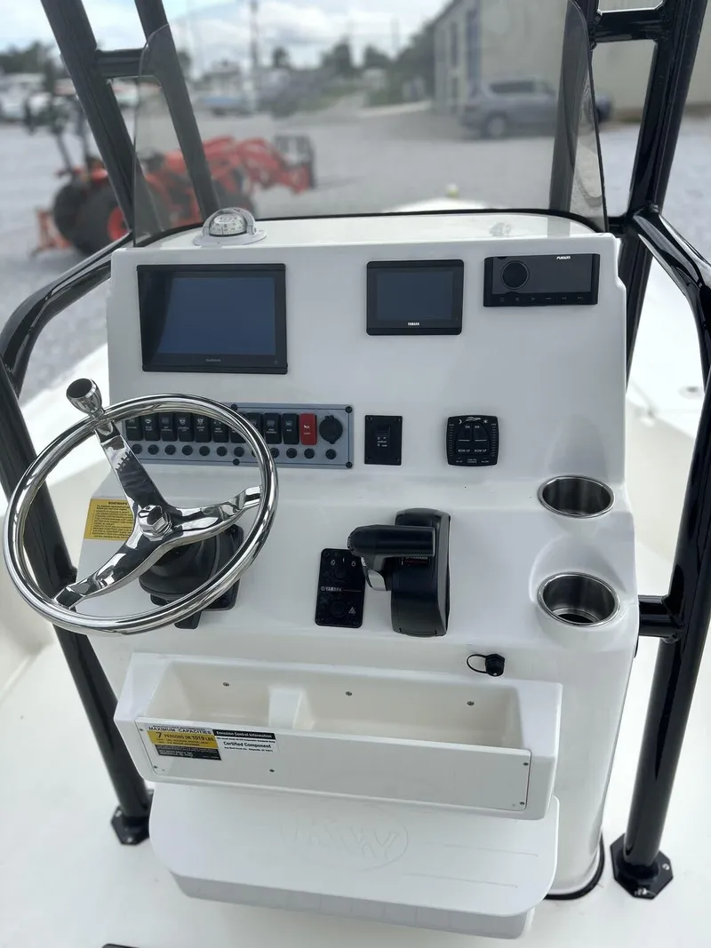 Slide: The Image of 2025 Key West 230BR boat console with steering wheel and electronic controls. - 6