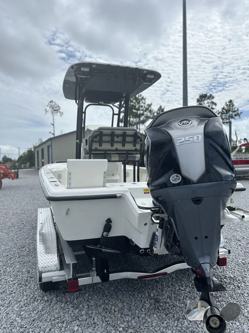 Slide: The Image of 2025 Key West 230BR boat with 250HP engine on trailer, outdoor setting. - 8