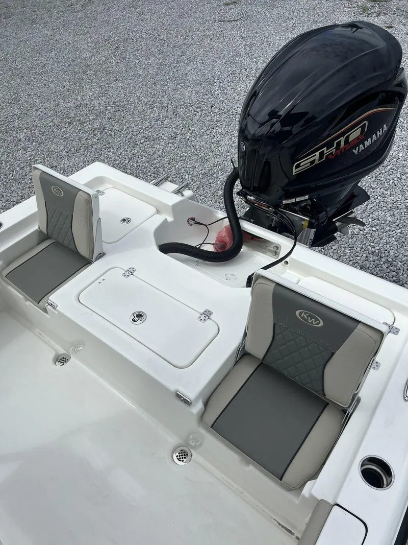 Slide: The Image of 2025 Key West 230BR boat with Yamaha engine, featuring cushioned seating and storage compartments. - 9