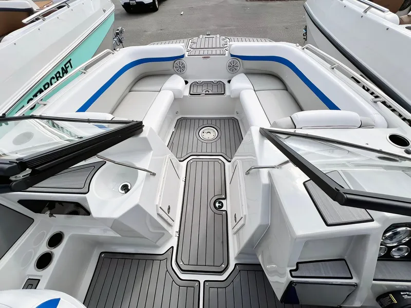 Slide: The Image of 2023 Starcraft SVX 190 OB boat interior with gray flooring and blue accents. - 10