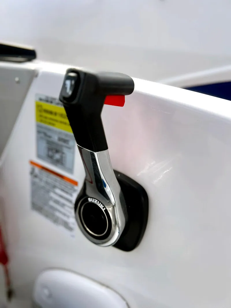 Slide: The Image of Throttle control on 2023 Starcraft SVX 190 OB boat, featuring Suzuki branding. - 12