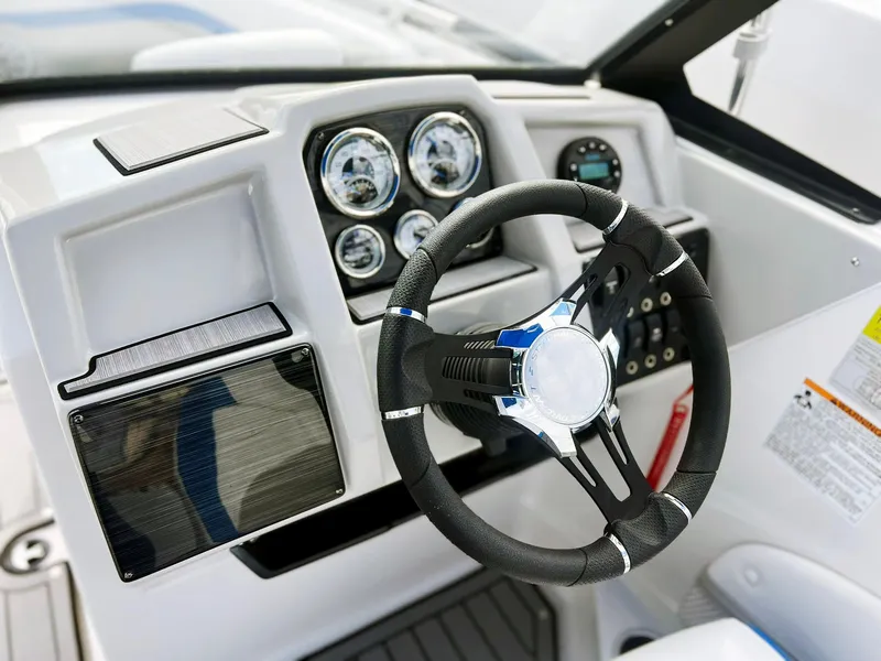 Slide: The Image of 2023 Starcraft SVX 190 OB boat dashboard with steering wheel and gauges. - 13