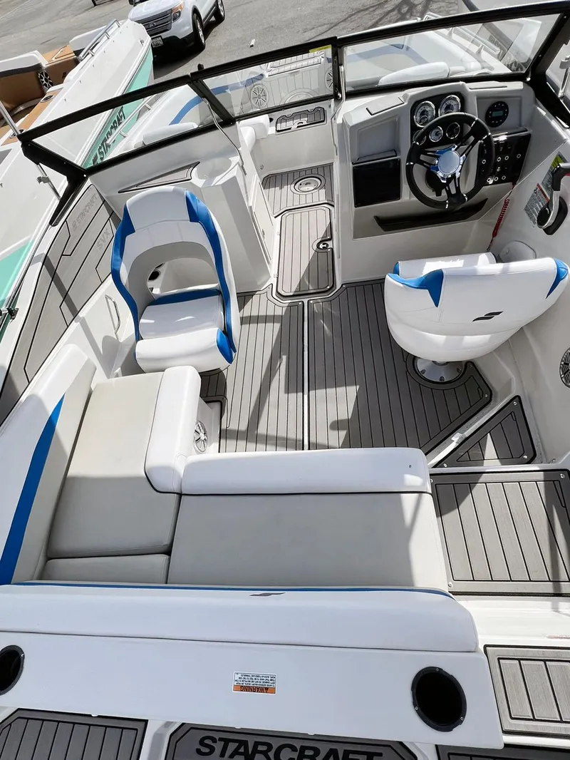 Slide: The Image of 2023 Starcraft SVX 190 OB boat interior with modern seating and steering console. - 15
