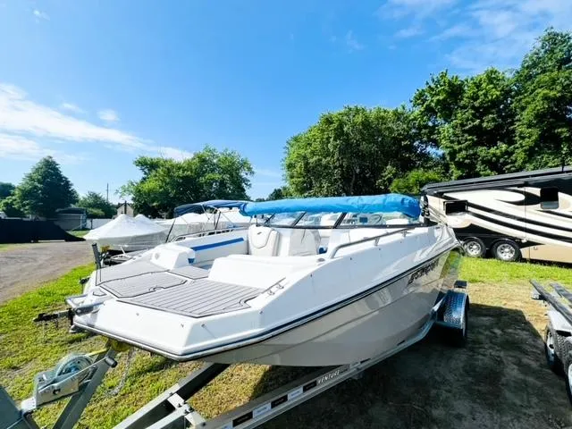 Slide: The Image of 2023 Starcraft SVX 190 OB boat on trailer, sunny day, surrounded by trees. - 17