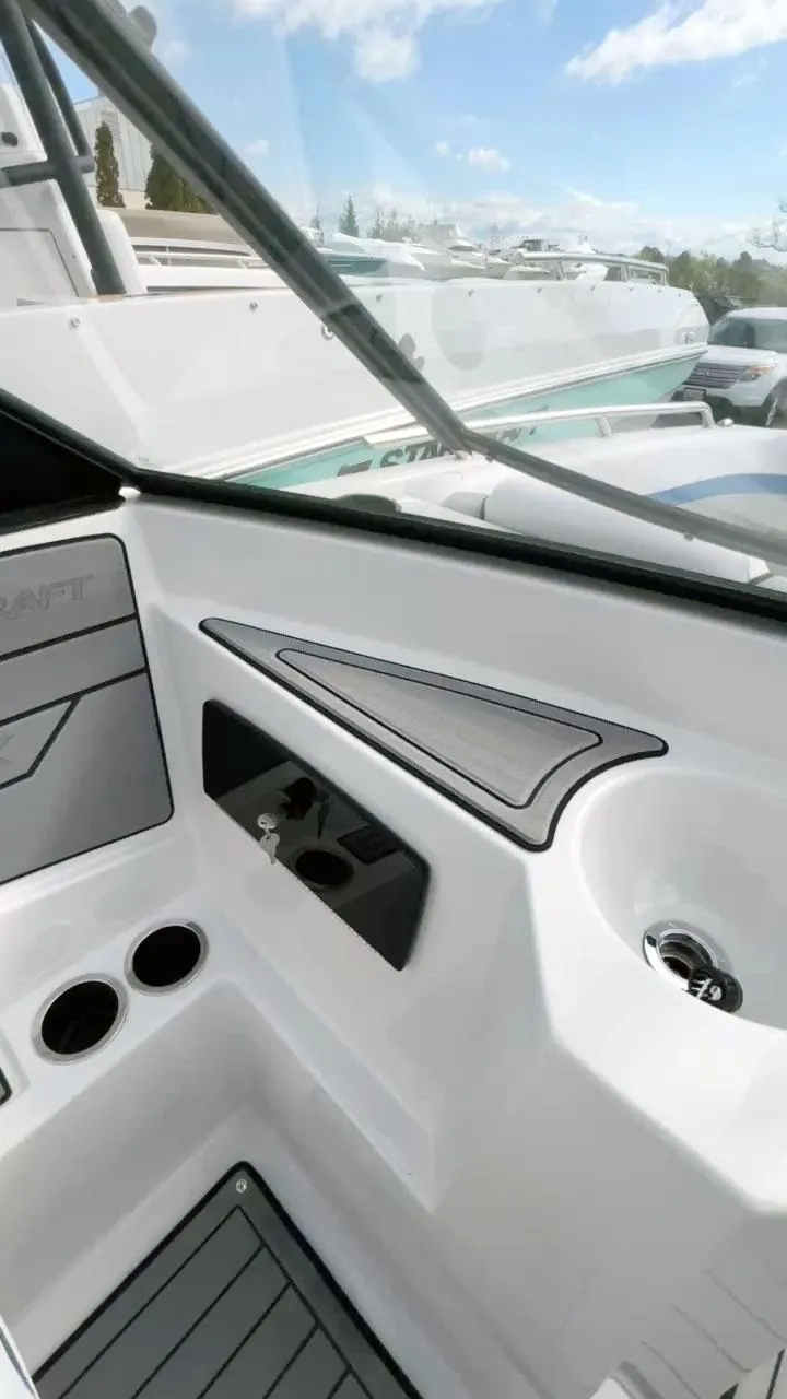 Slide: The Image of 2023 Starcraft SVX 190 OB boat interior with cup holders and sleek design. - 3