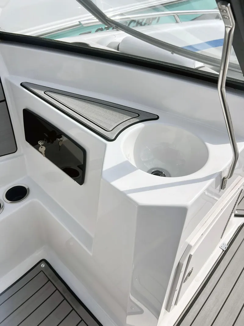 Slide: The Image of 2023 Starcraft SVX 190 OB boat interior with sink and storage compartments. - 4