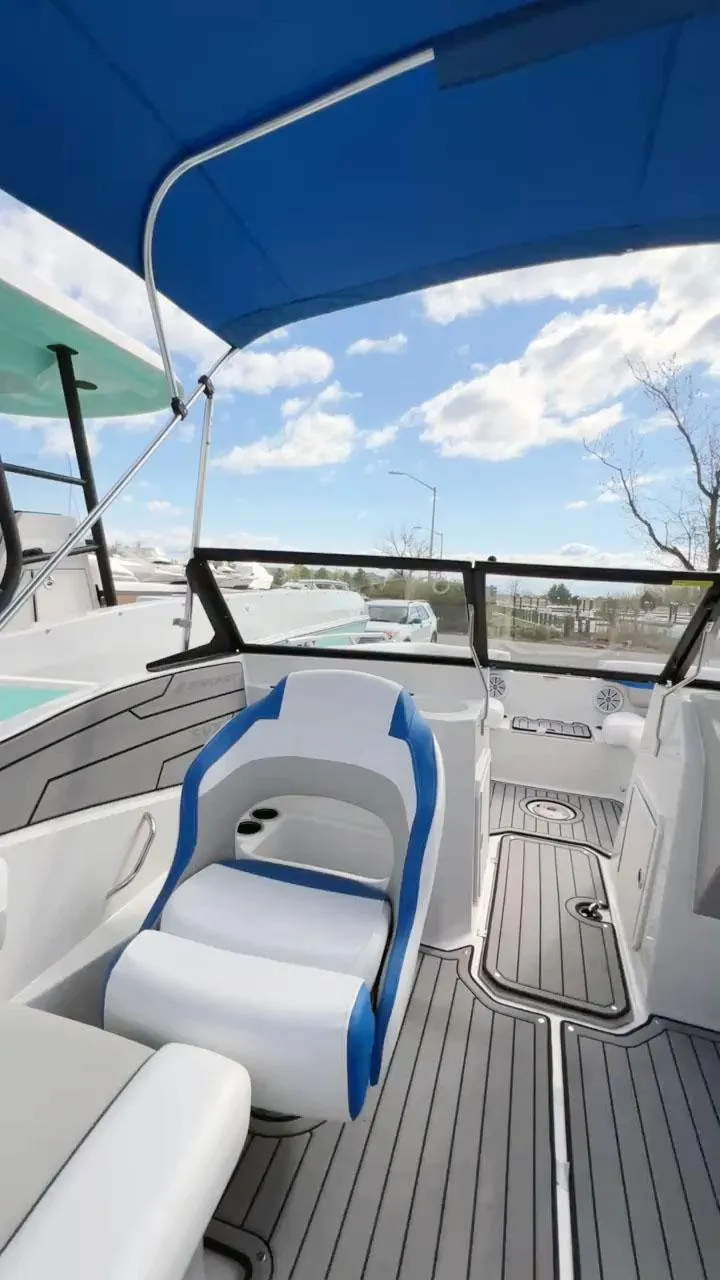 Slide: The Image of 2023 Starcraft SVX 190 OB boat interior with blue canopy and modern seating. - 5