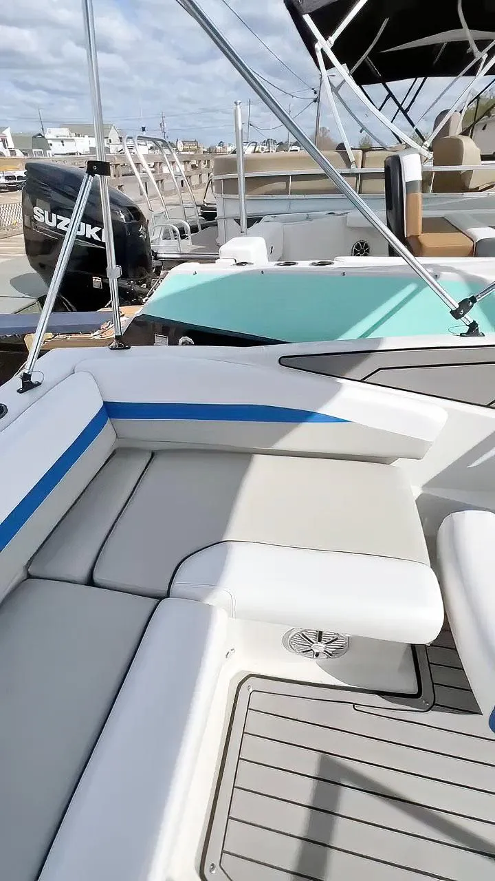 Slide: The Image of 2023 Starcraft SVX 190 OB boat interior with seating and Suzuki outboard motor. - 6