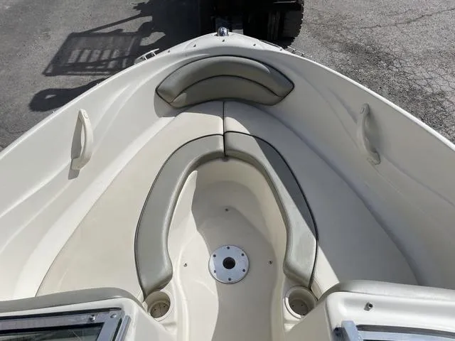 Slide: The Image of 2005 Sea Ray 180 Sport boat interior with cushioned seating and clean deck. - 10
