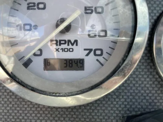 Slide: The Image of Close-up of 2005 Sea Ray 180 Sport RPM gauge showing 384.9 hours. - 12