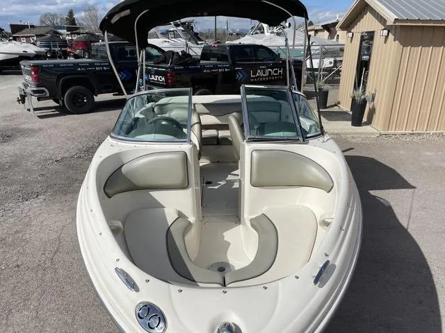 Slide: The Image of 2005 Sea Ray 180 Sport boat with open bow seating, parked outdoors. - 6