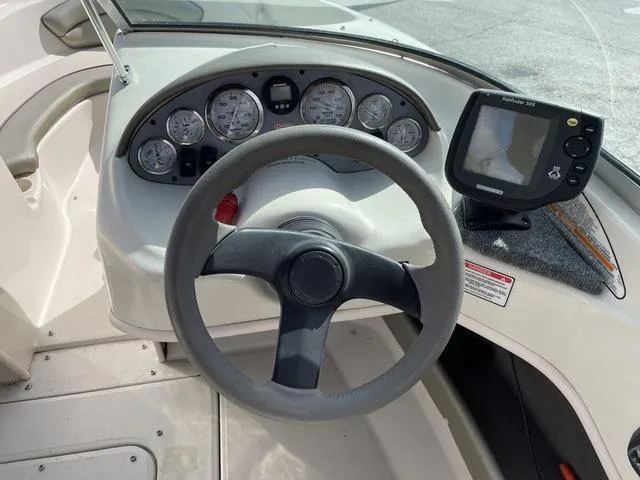 Slide: The Image of 2005 Sea Ray 180 Sport dashboard with steering wheel and gauges. - 9