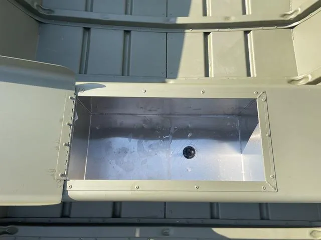 Slide: The Image of 2025 Lowe 1648M boat interior with open storage compartment. - 5