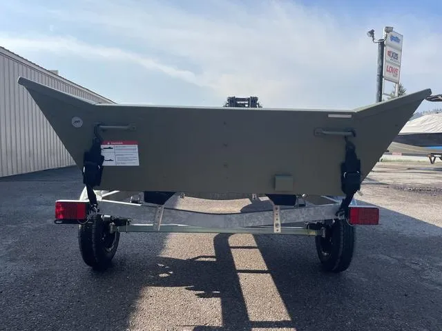 Slide: The Image of 2025 Lowe 1648M boat on trailer, parked outdoors. - 6