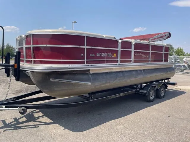 Slide: The Image of 2019 South Bay 222CR 2.75 pontoon boat on trailer, red exterior. - 7
