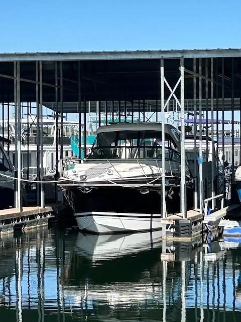 Slide: The Image of 2015 Formula 34 PC boat docked in a marina under a covered structure. - 1